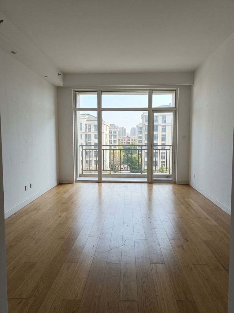 Empty room virtually staged with furniture (before)